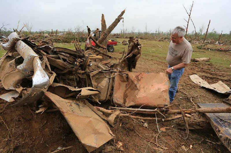 Arkansas Democrat-Gazette/RICK MCFARLAND --04/28/14--  Don Mallory, who's brother David Mallory, 58, was killed when his house was destroyed by the tornado that hit Vilonia Sunday night looks at the twisted remains of a 1955 Chevy that was one of his brother's prized posessions.
