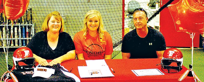 Staff Photo MARK HUMPHREY Jordin Smith, Farmington senior, flanked by her parents, Lorinda and Dwayne Smith, signed a national letter of intent Friday to play women&#8217;s college softball at Hendrix College in Conway.