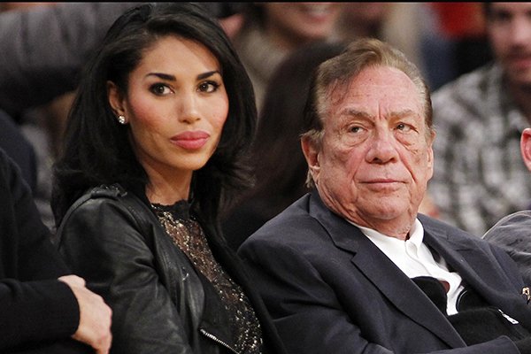 In this Dec. 19, 2010, file photo, Los Angeles Clippers owner Donald Sterling, right, and V. Stiviano, left, watch the Clippers play the Los Angeles Lakers during an NBA preseason basketball game in Los Angeles. NBA Commissioner Adam Silver is intent on moving quickly in dealing with the racially charged scandal surrounding Clippers owner Sterling. The NBA league will discuss its investigation Tuesday, April 29, 2014, before the Clippers play Golden State in Game 5 of their playoff series. (AP Photo/Danny Moloshok, File)