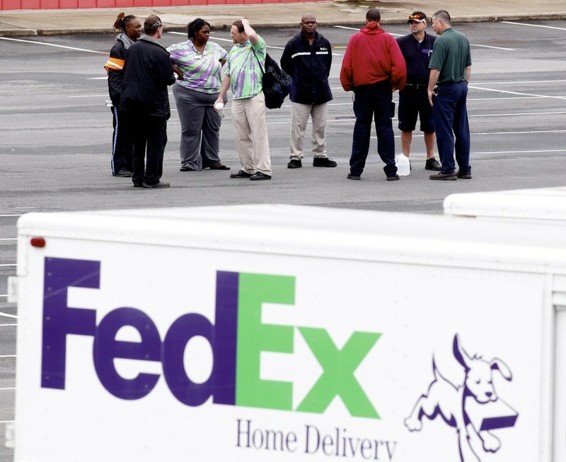 Fed-Ex employees and friends wait at a staging area at a skating rink after a shooting at a FedEX Corp facility at an airport in Kennesaw, Ga., on April 29, 2014. At least six people were reported hospitalized from wounds according to local reports. 