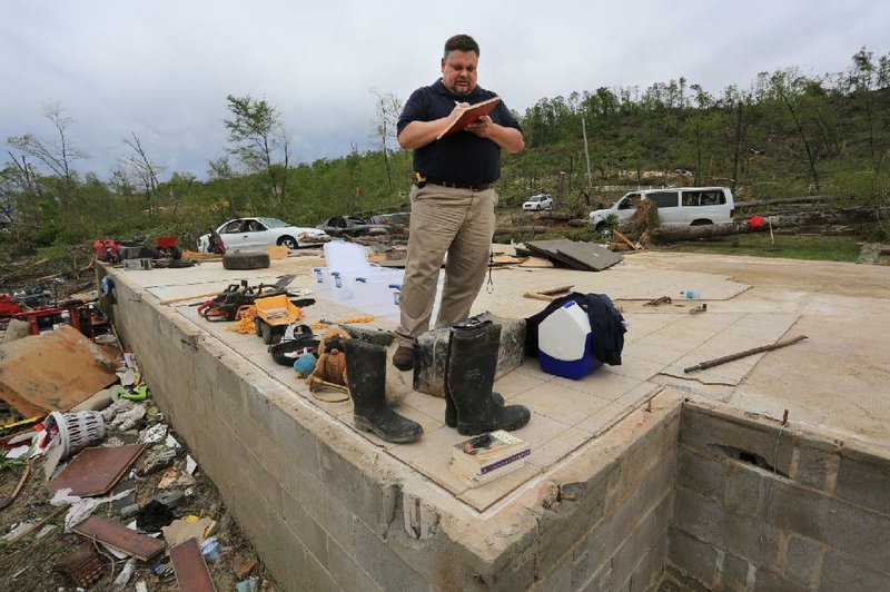 J. Greg Crump of Chattanooga, Tenn., a general adjuster for Safeco Insurance, on Tuesday assesses the damage done to the home of Robert Tittle and his family on Deer Drive near Paron. The home was demolished by a tornado Sunday night that killed Tittle and two of his daughters, Tori, 20, and Rebekah, 14. Tittle’s wife, Kerry, and their seven other children survived but were injured. 