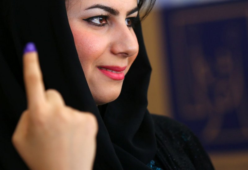 An Iraqi Kurdish woman shows her ink-stained finger after casting her vote at a polling station in Irbil, north of Baghdad, Iraq, on Wednesday, April 30, 2014. Iraq is holding its third parliamentary elections since the U.S.-led invasion that toppled dictator Saddam Hussein. 