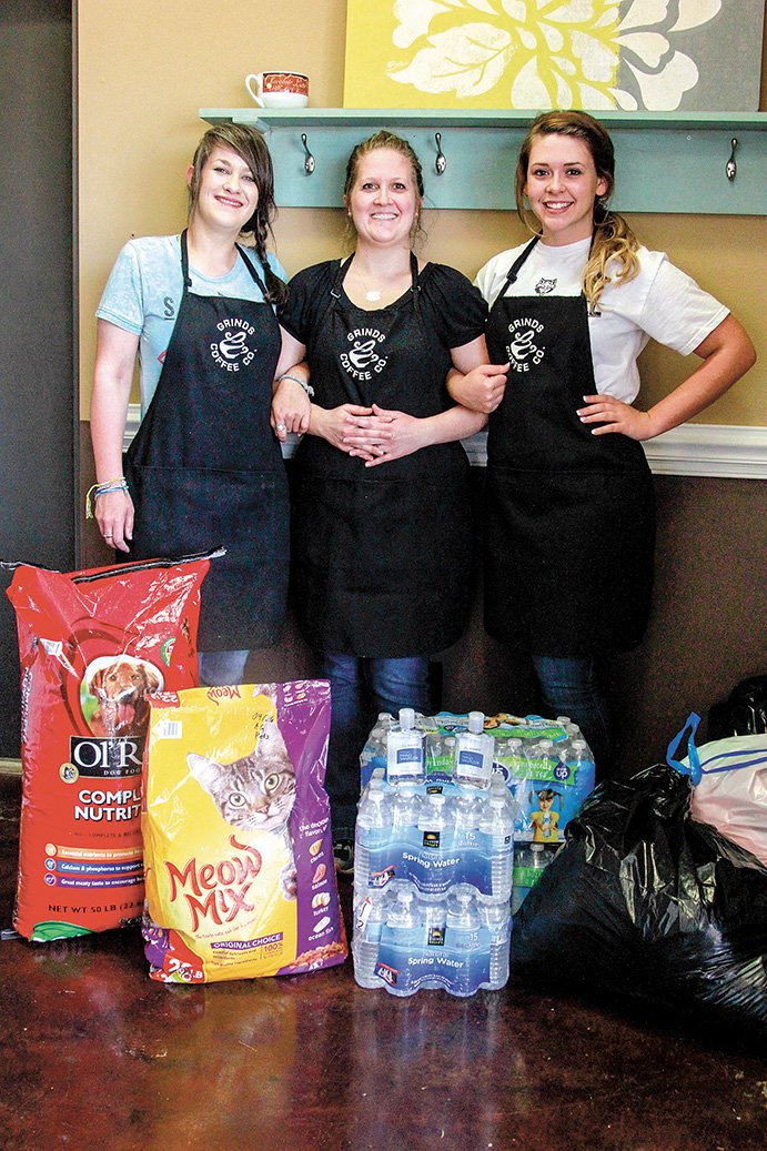 From left, Ashley Wilkerson, Laura Waller and Bailee Uhiren stand with some of the donations they collected at Grinds Coffee Co. in Cabot.
