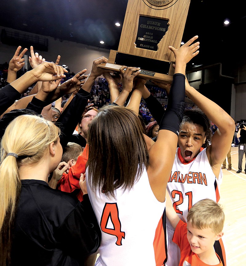 Malvern Lady Leopards No. 4 Raven Baker and No. 21 Akasha Westbrook are joined by teammates, coaches and fans as they celebrate the team’s second consecutive Class 4A state championship following a win over Central Arkansas Christian. Over the past two seasons, Malvern has compiled a 62-4 record.