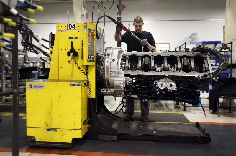 Jon Wyand works on a truck-engine assembly line at Volvo Trucks’ powertrain manufacturing facility in Hagerstown, Md., in March. On Wednesday, the U.S. Commerce Department said the nation’s gross domestic product grew at a 0.1 percent annual pace in the first three months of 2014. 