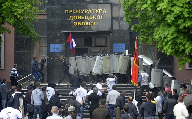 Pro-Russian activists clash with police Thursday at the regional administration building in Donetsk, Ukraine. As more troubles roiled the east, Russian President Vladimir Putin demanded Ukraine pull its troops from the region. 