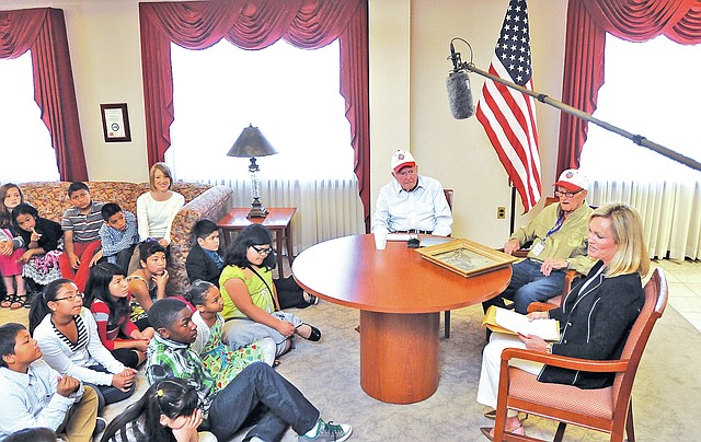 STAFF PHOTO BEN GOFF Jones fourth-graders listen as World War II veterans Forrest Strickler, from left, and Russell share memories Thursday of the war and previous Arkansas Honor Flights with Sara Lilygren of Tyson Foods.