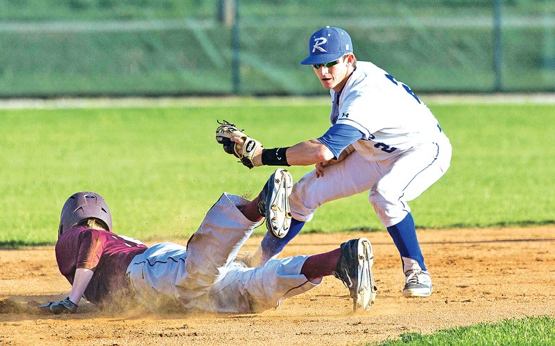 Special to NWA Media David J. Beach Timmy Seldomridge of Rogers High tags out Siloam Springs&#8217; Matthew Matheny on Thursday during the second game at Veterans Park in Rogers.