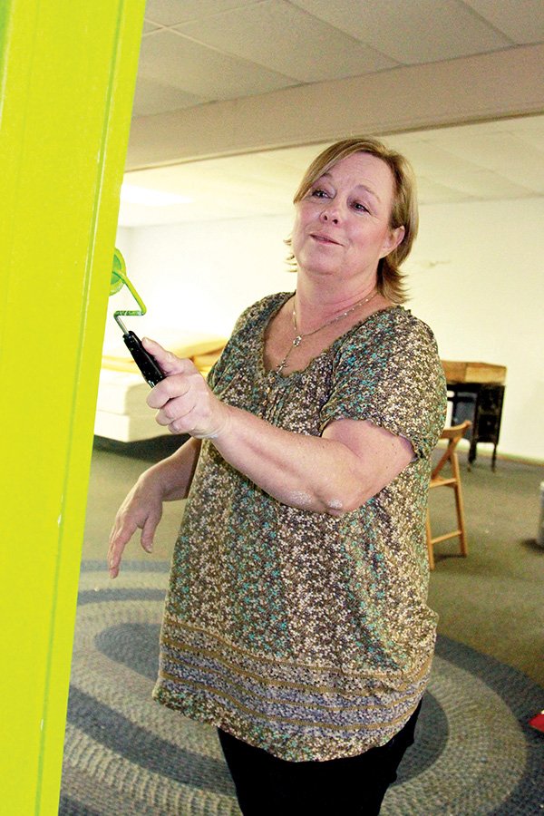 Julie Bohannan paints the interior of the new Cabot Community Outreach Thrift Store.