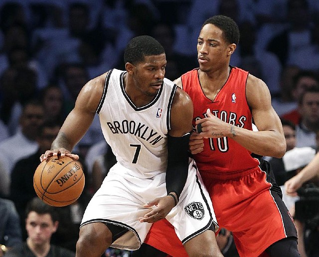 Toronto Raptors' DeMar DeRozan (10) defends Brooklyn Nets' Joe Johnson (7) during the first half of Game 6 of the opening-round NBA basketball playoff series Friday, May 2, 2014, in New York. (AP Photo/Frank Franklin II)