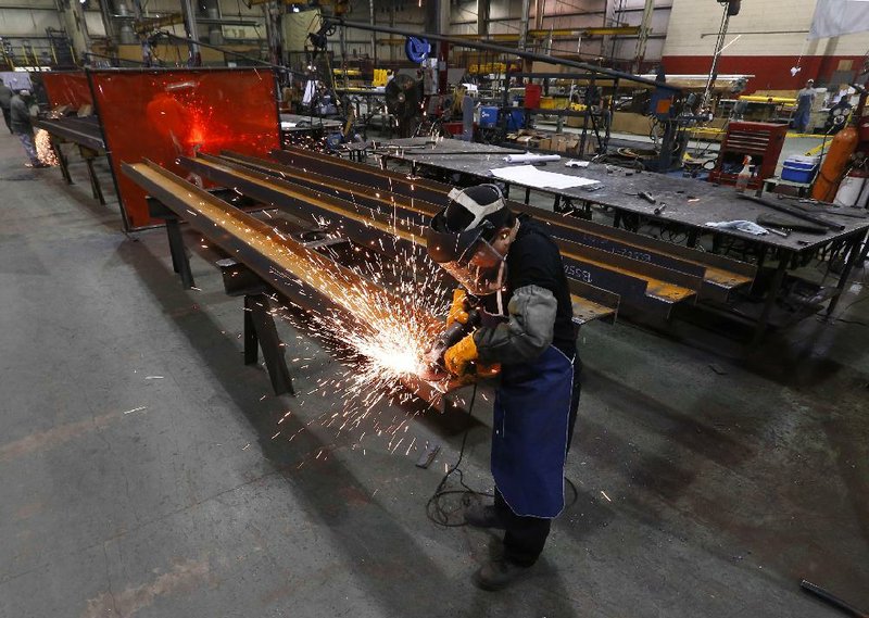 In this Thursday, Jan. 23, 2014 photo, Jesus Rodriguez grinds steel at the IDEAL Group in Detroit. The Commerce Department releases factory orders for March on Friday, May 2, 2014. (AP Photo/Paul Sancya)