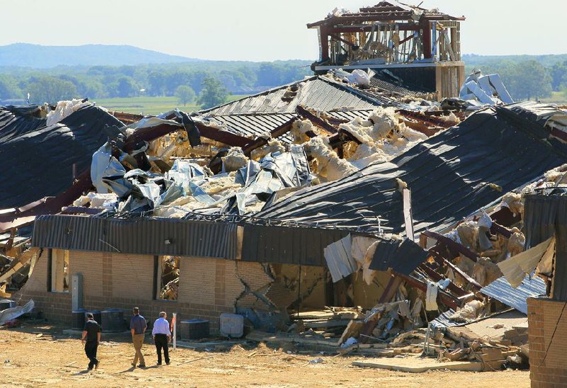 Nabholz project manager Lance Wright (left) leads Micah Moore (center) and Ron Callan on a tour Friday of the tornado-damaged Vilonia Intermediate School, which had been under construction for more than a year. Plans call for starting over on the 95,000-square-foot building and rebuilding it in the same spot. 