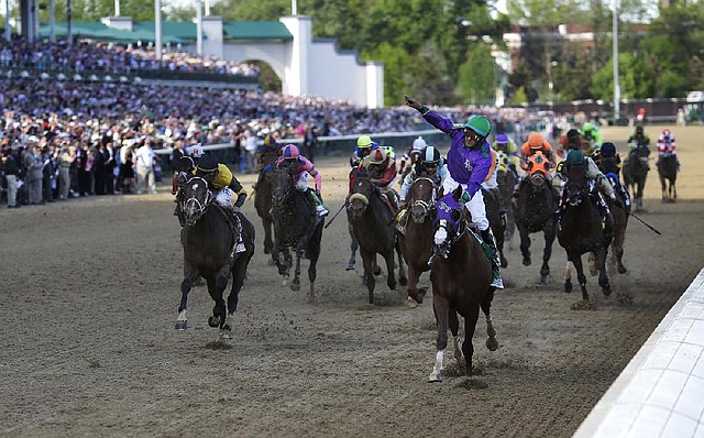 Victor Espinoza rides favored California Chrome to a 1¾-length victory over Commanding Curve (far left) and Arkansas Derby winner Danza in the 140th Kentucky Derby on Saturday at Churchill Downs in Louisville, Ky. Saturday’s winning ride by Espinoza was his second in the Derby, the first coming in 2002 on War Emblem. 