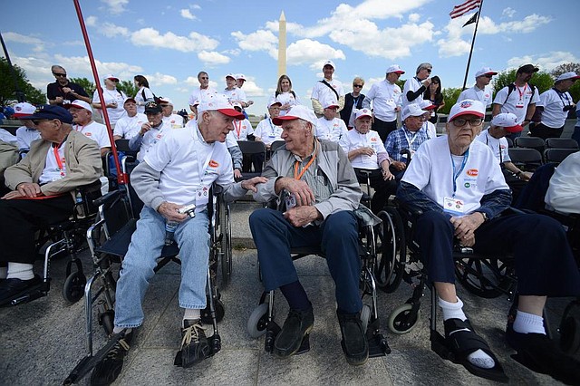 Paul Bonner (left) chats with Jerry Davis as they wait with Fred Pflederer (right) and other Arkansas veterans for group photos Saturday at the World War II Memorial in Washington. 