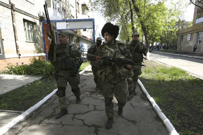 Pro-Russian militiamen prowl in a street Saturday in Kramatorsk amid reports of fighting in the city 10 miles south of the eastern Ukrainian city of Slovyansk.


