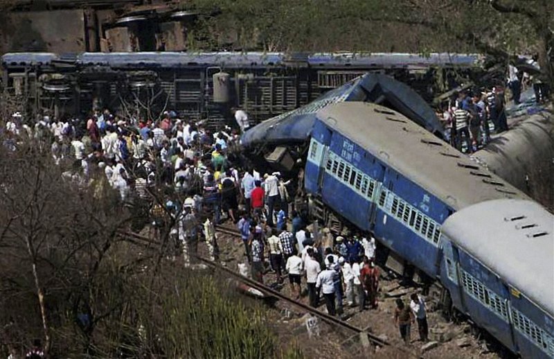 People gather around a passenger train that derailed near Roha station, 70 miles south of Mumbai, Maharashtra state, India, Sunday, May 4, 2014. The cause of the accident was not immediately known. 