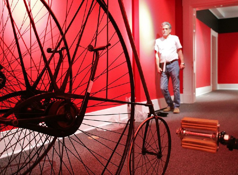 Arkansas Democrat-Gazette/CELIA STOREY
Bill Gatewood and Jo Ellen Maack visit April 28 a red room full of antique and BMX bicycles waiting to be arranged in exhibit rooms for the show  ‚ÄúDifferent Spokes‚Äù  at the Old State House Museum.