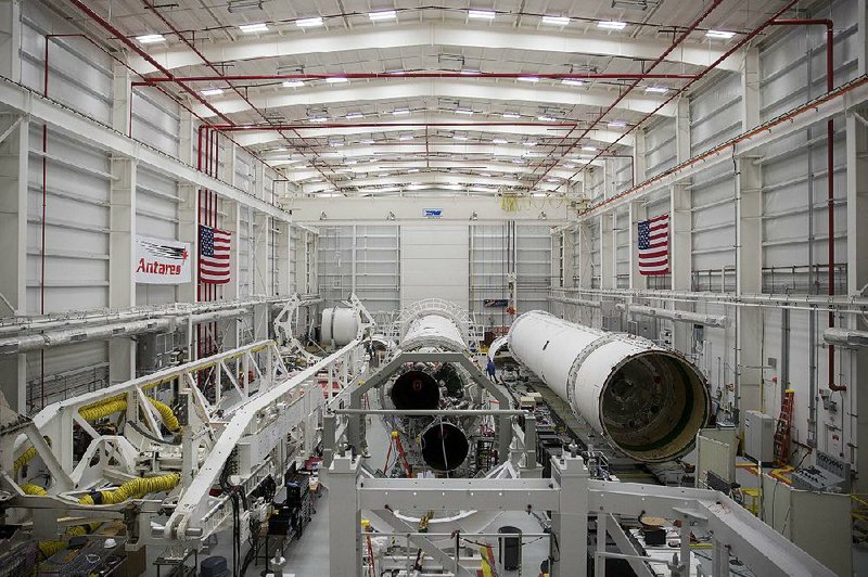 Antares rockets sit inside the Orbital Sciences Corp. horizontal integration facility (HIF) at the National Aeronautics and Space Administration (NASA) Wallops Space Facility in Wallops Island, Virginia, U.S., on Tuesday, April 1, 2014. Alone among space companies, Orbital Sciences Corp. launches rockets from NASA's Wallops Space Facility on the eastern shore of its home state of Virginia. Orbital is soaring on plans to combine with Alliant Techsystems Inc. (ATK)'s aerospace and defense businesses, tripling revenue and uniting two longtime launch partners. Alliant helps power the Antares rocket, key to Orbital's growth in the estimated $7 billion market for building and launching midsized satellites and spacecraft. Photographer: Andrew Harrer/Bloomberg