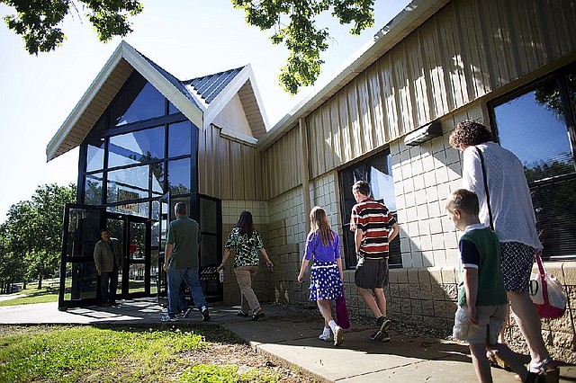Arkansas Democrat-Gazette/MELISSA SUE GERRITS - 05/04/2014 -  Attendees walk into Mayflower High School's Cafeterium for services of Lifeline Church May 4, 2014. The church lost their building and several community members' property was affected. 