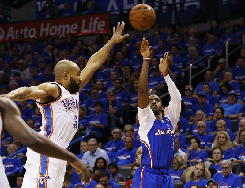 Los Angeles Clippers guard Chris Paul (3) shoots in front of Oklahoma City Thunder guard Derek Fisher (6) in the second quarter of Game 1 of the Western Conference semifinal NBA basketball playoff series in Oklahoma City, Monday, May 5, 2014. (AP Photo/Sue Ogrocki)