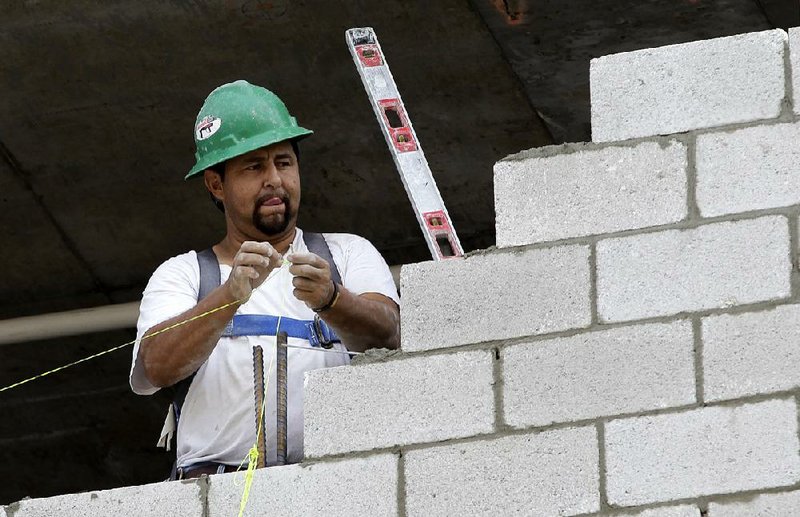 In this April 16, 2014 photo, a worker prepares to align blocks during the construction of a new building in the South Pointe area of Miami Beach, Fla. The Institute for Supply Management, a group of purchasing managers, issues its index of non-manufacturing (service-sector) activity for April on Monday, May 5, 2014. (AP Photo/Alan Diaz)