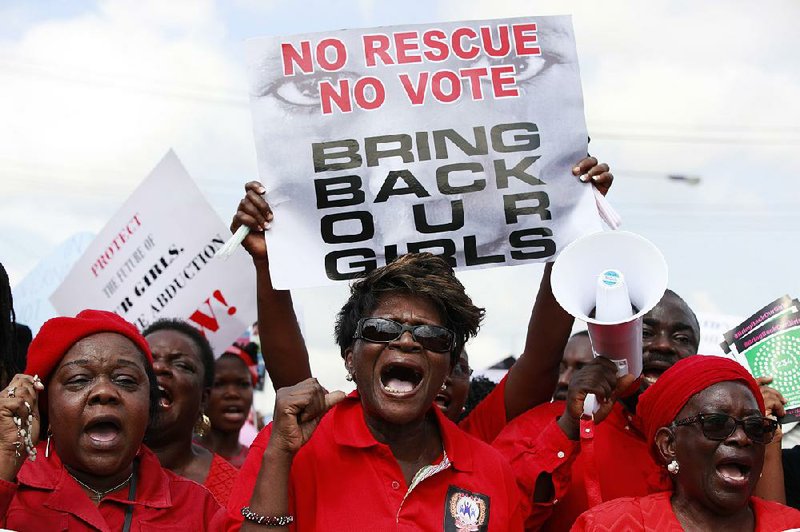 Women attend a demonstration calling on government to rescue kidnapped school girls of a government secondary school Chibok, in Lagos, Nigeria, Monday, May. 5, 2014,  A leader of a protest march for 276 missing schoolgirls said that Nigeria's First Lady ordered her and another protest leader arrested Monday, expressed doubts there was any kidnapping and accused them of belonging to the Islamic insurgent group blamed for the abductions. Saratu Angus Ndirpaya of Chibok town said State Security Service agents drove her and protest leader Naomi Mutah Nyadar to a police station Monday. (AP Photo/ Sunday Alamba)