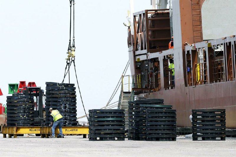 A dockworker loads an Amsterdam-bound ship at the Port of Cleveland last month. The U.S. trade deficit narrowed in March, the Commerce Department said. 