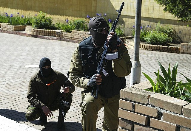 Pro-Russia gunmen try to block an Interior Ministry base containing Ukrainian riot police in Donetsk, Ukraine, on Tuesday. 
