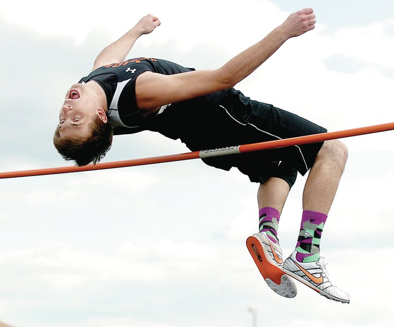 Photo by Randy Moll Terence Pierce, Gravette senior, clears the bar during high jump competition at the Gravette district track meet on Thursday, May 1, 2014.