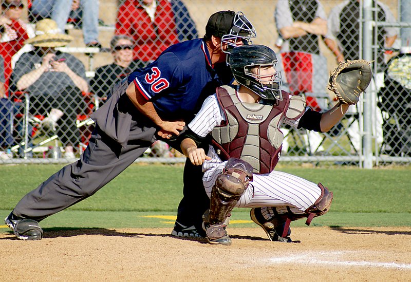 Photo by Randy Moll Brent Barker, Gentry&#8217;s catcher, waits for the pitch with the home plate umpire looking over his shoulder during Friday&#8217;s playoff game against Farmington at Prairie Grove.