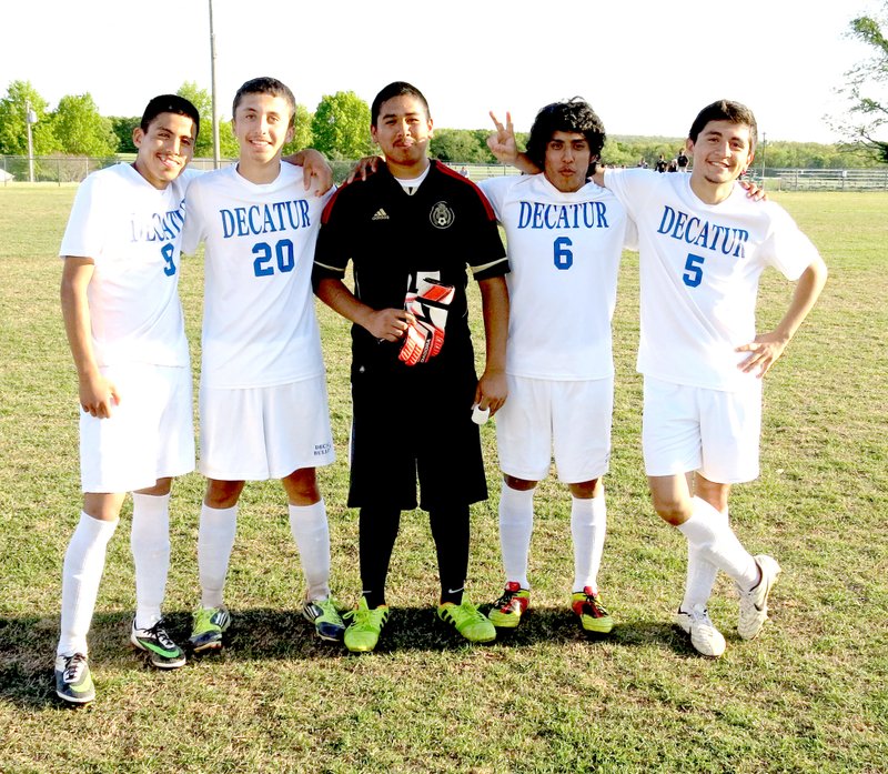 Photo by Mike Eckels Decatur Bulldog seniors Tony Mendoza (left), Orlando Aguirre, Alex Cordova, Donovan Case and Eduardo Hinojosa pose after their victory against the Prairie Grove Tigers May 2. This marked the last game they would play in Bulldog Stadium. The Bulldogs handed the Tigers a 4 to 0 loss.