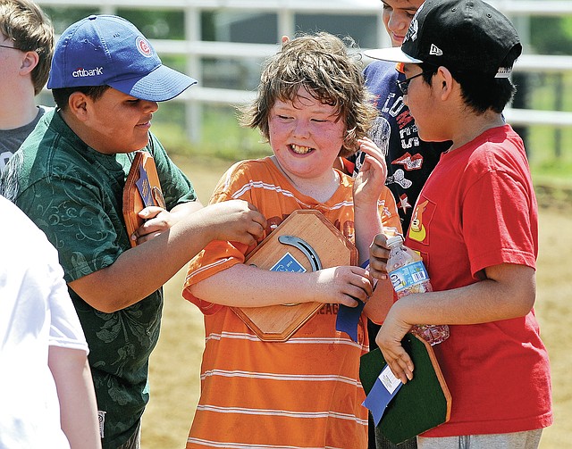STAFF PHOTO BEN GOFF Marco Tinoco, 10, from left, Leroy Parson, 10, and Roberto Turcios, 11, from Northside, laugh Tuesday after receiving plaques in the annual Special Olympics equestrian event in Bentonville.