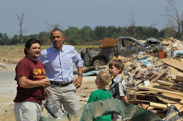 President Barack Obama visits with tornado victims Daniel Smith and his sons Garrison Dority (left) and Gabriel Dority on Wednesday in Vilonia. Smith welcomed the president, telling him: “Man, it’s good to see you, sir.” 