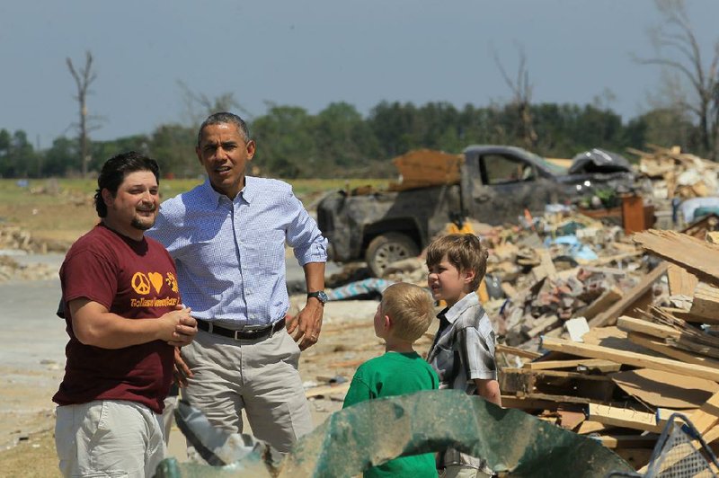 President Barack Obama visits with tornado victims Daniel Smith and his sons Garrison Dority (left) and Gabriel Dority on Wednesday in Vilonia. Smith welcomed the president, telling him: “Man, it’s good to see you, sir.” 