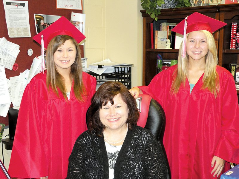 Cave City High School counselor Vickie Green poses with her twin daughters, Allison, left, and Ashley. The twins, whose father, Steven, is superintendent of the Cave City School District, are two of the six valedictorians at Cave City High School.