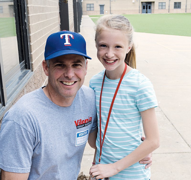 Tommy Bates visits his daughter Reagan at Vilonia Middle School on Wednesday. Bates and his family were in a storm shelter during the April 27 tornado that struck Vilonia, but their home was destroyed, along with their business, Vilonia Therapy Services. Bates said he plans to rebuild.