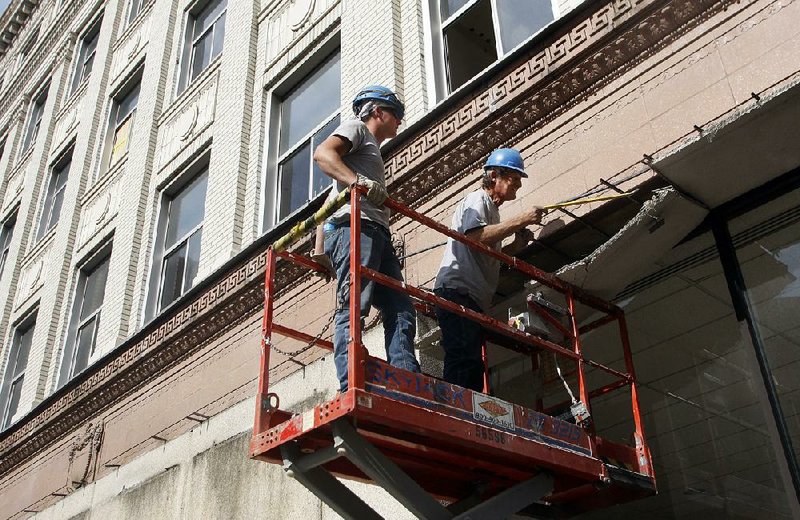Arkansas Democrat Gazette/JEFF MITCHELL - 05/07/2014 - James Wedge (R) and Patrick Gill remove the facade from the exterior of the Hall Bulding in downtown Little Rock, May 7, 2014.