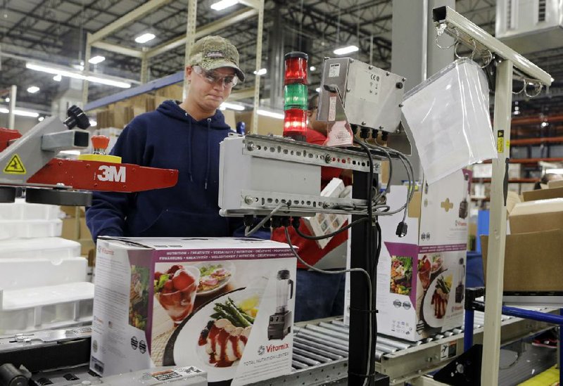 In this April 15, 2014 photo, completed blenders roll off the packaging line at the Vitamix manufacturing facility in Strongsville, Ohio. The Commerce Department reports on wholesale trade inventories for March on Friday, May 9, 2014. (AP Photo/Mark Duncan)