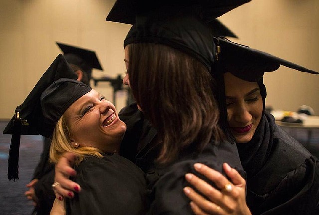 Arkansas Democrat-Gazette/MELISSA SUE GERRITS - 05/10/2014 -  	(l-r) Jenna Rhodes, Emily Wernsdorfer, and Aliyah Sarkar, celebrate together before officially graduating from the Clinton School of Public Service with masters in public service at the Statehouse Convention Center May 10, 2014. 