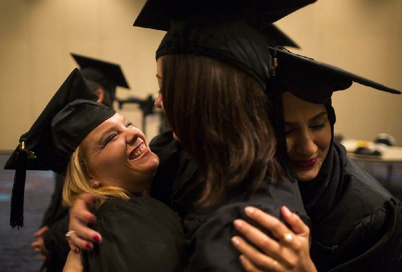 Arkansas Democrat-Gazette/MELISSA SUE GERRITS - 05/10/2014 -  	(l-r) Jenna Rhodes, Emily Wernsdorfer, and Aliyah Sarkar, celebrate together before officially graduating from the Clinton School of Public Service with masters in public service at the Statehouse Convention Center May 10, 2014. 