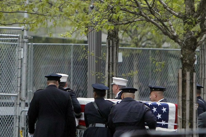 A coffin with the unidentified remains of victims of the Sept. 11, 2001, terrorist attacks is carried Saturday to the World Trade Center site in New York. The remains will be placed in an underground repository in the same building as the National September 11 Memorial Museum. 