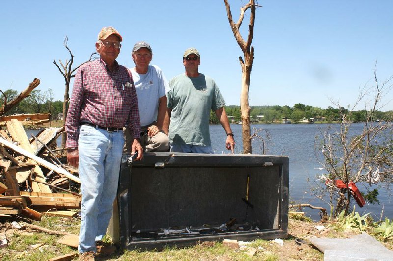 Louie Short (left) was huddled next to his large gun safe when his Mayflower home was struck by the April 27 tornado. The safe, which weighed more than 800 pounds, was ripped from the concrete slab and flung 80 yards into Lake Conway. Short’s sons, professional bass angler Kevin Short (center) and Conway detective David Short, helped recover it. 
