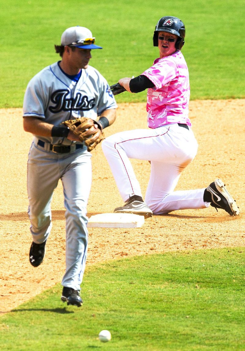 Arkansas Democrat-Gazette/MELISSA SUE GERRITS - 05/11/2014 -  	Travelers' Alex Allbritton looks over his shoulder to see Drillers' second baseman Taylor Featherston lose control of the ball to keep him safe after a base hit and bases loaded their game against May 11, 2014 at Dickey Stevens Stadium. 