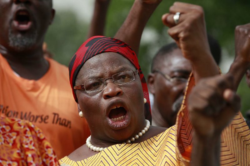 A woman shouts slogans,  during a rally calling on the Government to rescue the school girls kidnapped from the Chibok Government secondary school,  in Abuja, Nigeria, Sunday May 11, 2014. The failure to rescue the kidnapped girl students who remain captive after some four weeks has attracted mounting national and international outrage, and one of the teenagers who escaped from the Islamic extremists who abducted the hundreds of schoolgirls, science student Sarah Lawan said Sunday in an interview with The Associated Press the kidnapping was "too terrifying for words". (AP Photo/Sunday Alamba)