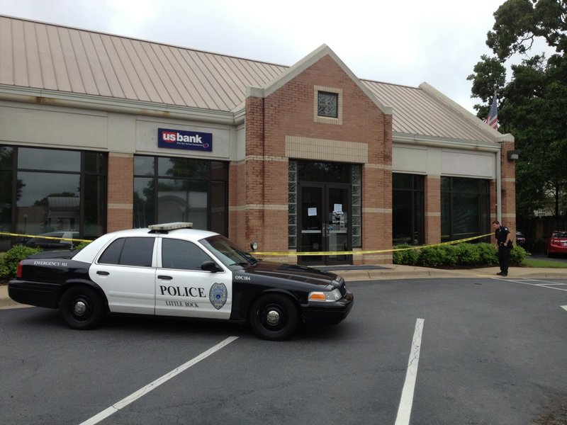 Police respond Tuesday, May 13, 2014, to a robbery at the US Bank at 5200 Kavanaugh Blvd. in Little Rock's Heights neighborhood.