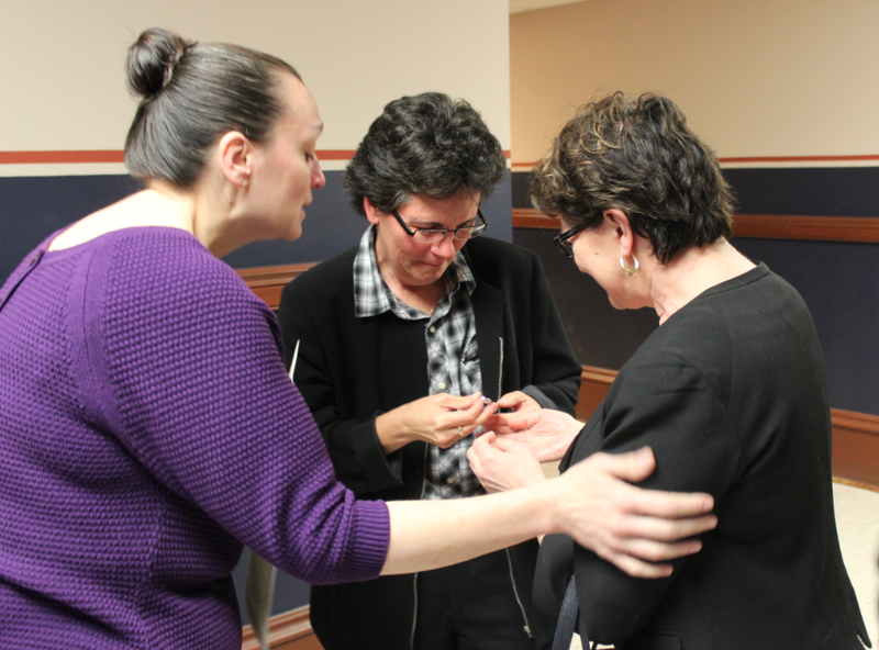 Lisa Weber, center, and Terri Langley-Weber, right, exchange rings during a wedding ceremony Tuesday at the Pulaski County courthouse officiated by Julie Gerlinger.