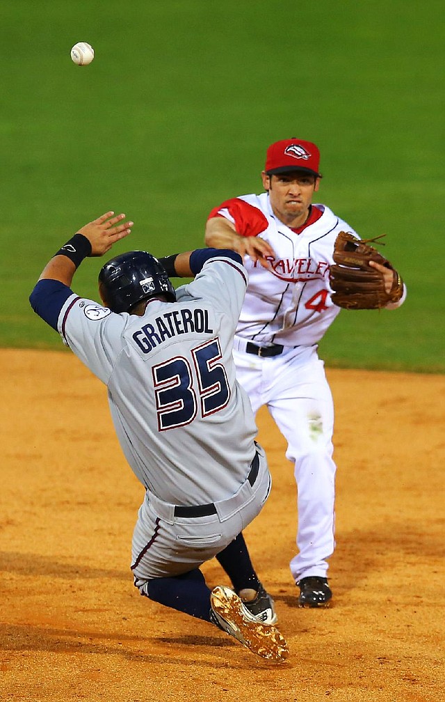 Arkansas shortstop Vance Albitz forces Northwest Arkansa’ Juan Graterol at second base in the fourth inning of the Travelers 4-3 victory Tuesday at Dickey-Stephens Park in North Little Rock. 