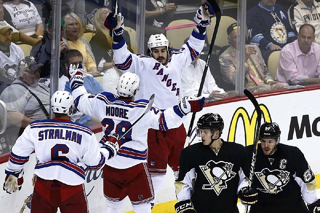 New York’s Brian Boyle (center) celebrates his first-period goal along with teammates Anton Stralman (6) and Dominic Moore during Tuesday night’s 2-1 victory over Pittsburgh. The Rangers won the series and advanced to the conference finals where they will face either Boston or Montreal. 