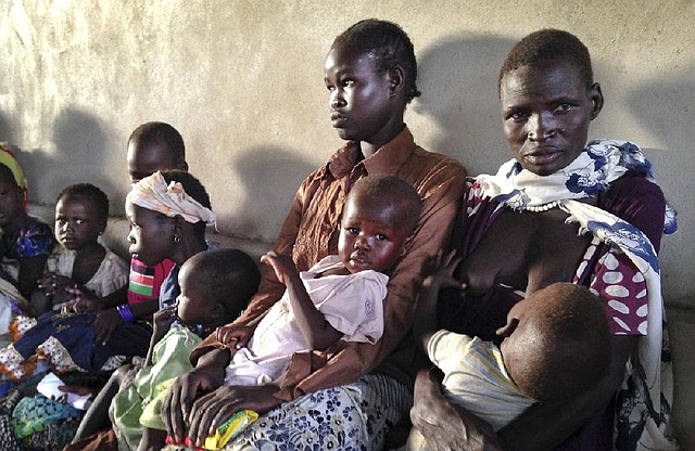 Women and children wait to be treated at a hospital Friday in Leer, South Sudan. 