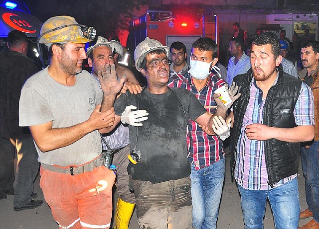 Medics help a rescued miner Tuesday after an explosion and fire at a coal mine killed at least 201 miners and left other workers trapped underground in Soma in western Turkey, a Turkish official said. 